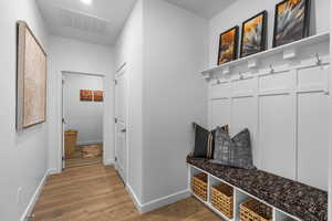 Mudroom with wood-type flooring