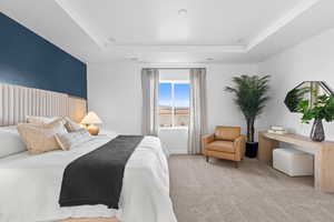 Bedroom featuring a tray ceiling and carpet