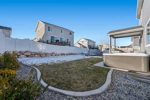 View of yard with a hot tub and a trampoline