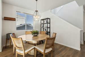 Dining area featuring dark hardwood / wood-style flooring and a chandelier