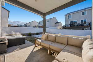 View of patio / terrace featuring a hot tub, grilling area, outdoor lounge area, and a mountain view