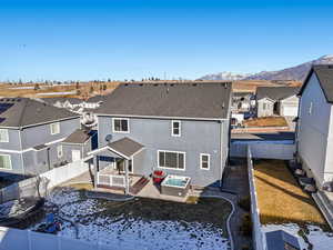 Rear view of house featuring a mountain view and a patio