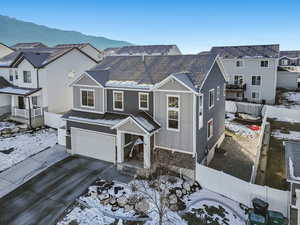 View of front of property with a garage and a mountain view