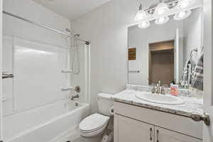 Full bathroom featuring vanity, toilet, and shower / bath combination