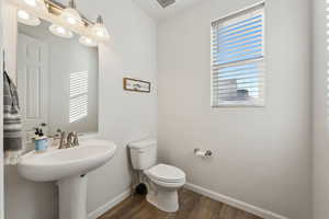 Bathroom with toilet and hardwood / wood-style floors