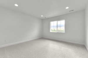 Empty room with carpet flooring and recessed lighting