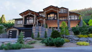 View of front of house featuring a balcony and a garage