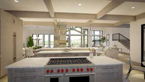 Kitchen featuring sink, beamed ceiling, an island with sink, a chandelier, and range with two ovens