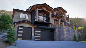 View of front of home featuring a garage and a balcony