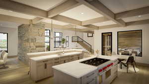 Kitchen featuring a healthy amount of sunlight, light hardwood / wood-style floors, a kitchen island, and light brown cabinets