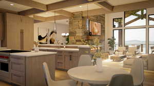 Kitchen featuring pendant lighting, designer range, a mountain view, beamed ceiling, and light brown cabinets