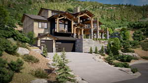 View of front of house with a garage and a balcony