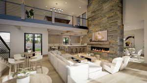 Living room with a towering ceiling, a stone fireplace, and light hardwood / wood-style floors