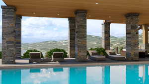 View of swimming pool with a mountain view and an outdoor hangout area