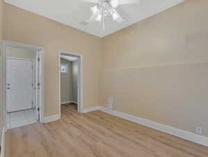 Unfurnished room with ceiling fan and light wood-type flooring