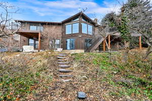 Back of property featuring a balcony & deck with incredible views