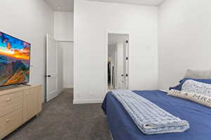 Bedroom with dark colored carpet