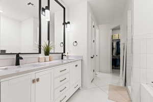 Bathroom featuring tile patterned floors and vanity