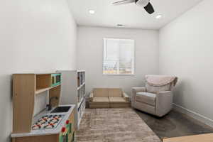 Sitting room featuring ceiling fan and sink