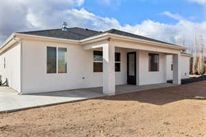 Rear view of house featuring a patio area