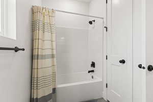 Bathroom featuring shower / bath combo with shower curtain