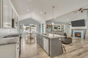 Kitchen featuring pendant lighting, sink, white cabinets, and appliances with stainless steel finishes