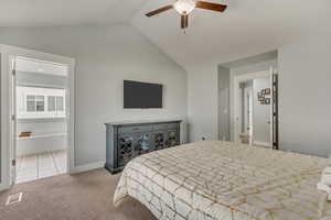 Primary Bedroom Vw2 Bedroom featuring light carpet, ensuite bath, vaulted ceiling, and ceiling fan