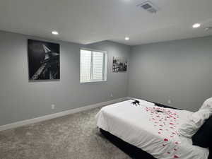 Carpeted bedroom featuring a textured ceiling