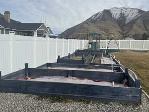 Exterior space featuring a yard, a playground, and a mountain view