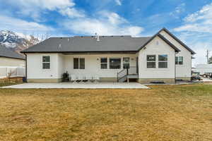 Back of property with a yard and a patio area