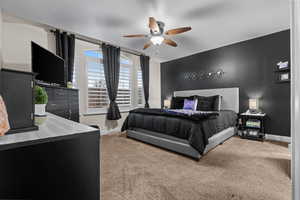 Bedroom featuring ceiling fan and carpet flooring