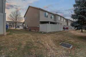 Property exterior at dusk featuring a yard