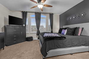 Bedroom featuring ceiling fan and carpet flooring