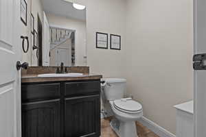 Bathroom featuring tile patterned floors, vanity, and toilet