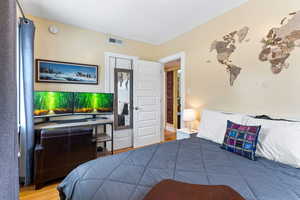 Bedroom with hardwood / wood-style floors