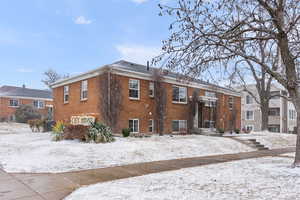 View of snow covered back of property