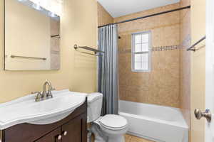 Full bathroom featuring tile patterned flooring, vanity, shower / bathtub combination with curtain, and toilet