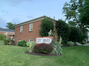 Community sign featuring a lawn