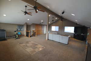 Unfurnished living room with lofted ceiling and carpet