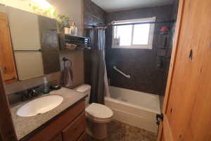 Full bathroom with vanity, toilet, and shower / tub combo