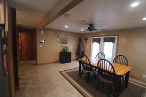 Dining space with ceiling fan and french doors