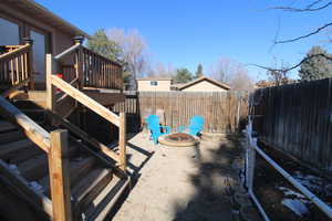 View of yard with a wooden deck and an outdoor fire pit