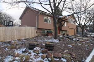 View of snow covered exterior featuring a garage