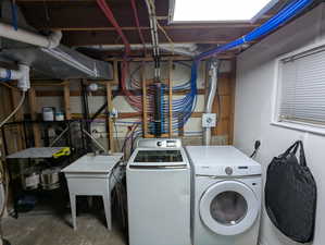 Washroom featuring independent washer and dryer