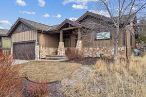 View of front of property with a garage and covered porch