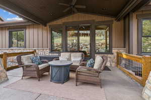 View of patio with an outdoor living space with a fire pit and ceiling fan