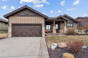 View of front facade featuring a garage and a porch