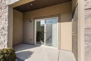 Doorway to property featuring a patio area