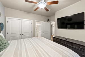 Bedroom featuring ceiling fan, a closet, and a textured ceiling