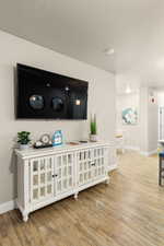 Room details with wood-type flooring and a textured ceiling